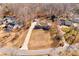 Aerial view of a brick home nestled among mature trees in a tranquil neighborhood setting at 11 Heritage Ln, Shelby, NC 28150