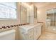 Traditional bathroom features a vanity with a marble countertop and a built-in cabinet with a mirror at 11 Heritage Ln, Shelby, NC 28150