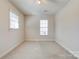Bedroom with carpet, neutral walls, ceiling fan and two windows, creating a cozy and bright atmosphere at 11 Heritage Ln, Shelby, NC 28150