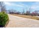 A long concrete driveway leads to a traditional brick home with a manicured lawn and mature trees at 11 Heritage Ln, Shelby, NC 28150