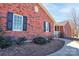 Traditional brick home with lush landscaping, black shutters, and a welcoming front porch at 11 Heritage Ln, Shelby, NC 28150
