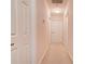 Hallway with neutral carpet, white trim, and multiple doors leading to various rooms in the home at 11 Heritage Ln, Shelby, NC 28150