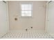 Functional laundry room features tile flooring and a window for natural light at 11 Heritage Ln, Shelby, NC 28150