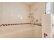 Walk-in shower features tiled walls, a built-in bench, and accessible fixtures at 11 Heritage Ln, Shelby, NC 28150