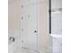 Bathroom showcases a white door next to a tub with tile surround and a glass shower at 1114 Roderick Dr, Fort Mill, SC 29708