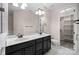 Bathroom features a double sink vanity with dark cabinets and a marble countertop, complemented by tile flooring and neutral walls at 1114 Roderick Dr, Fort Mill, SC 29708