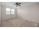 Cozy bedroom with neutral carpet, a ceiling fan, and a window, creating a serene and comfortable atmosphere at 1114 Roderick Dr, Fort Mill, SC 29708