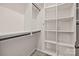 Walk in closet features custom shelving and organization options with rods and a tiled floor at 1114 Roderick Dr, Fort Mill, SC 29708