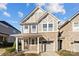 Charming two-story home featuring stone accents, a one-car garage, and a covered front porch, ideal for relaxing at 1114 Roderick Dr, Fort Mill, SC 29708