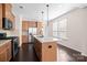 Spacious kitchen with a center island, stainless steel appliances, granite countertops, and natural wooden cabinetry at 1114 Roderick Dr, Fort Mill, SC 29708