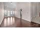 Spacious living room with hardwood floors, high ceilings, and natural light, showcasing access to the outdoors at 1114 Roderick Dr, Fort Mill, SC 29708