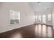 Bright living room featuring hardwood floors, large windows, and doors that provide ample natural light at 1114 Roderick Dr, Fort Mill, SC 29708