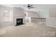 Spacious living room with large windows, a ceiling fan, a fireplace and iron railing at 1114 Roderick Dr, Fort Mill, SC 29708