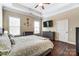 Bedroom features neutral walls, tray ceiling, and hardwood floors, and TV at 120 Sycamore Dr, Lancaster, SC 29720