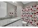 Modern bathroom with granite countertop, white cabinetry, and a decorative floral shower curtain at 122 Round Rock Rd, Troutman, NC 28166
