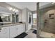 Bright bathroom with granite counters, double vanity, and tile shower with a glass enclosure at 122 Round Rock Rd, Troutman, NC 28166