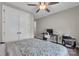 Comfortable bedroom features a floral comforter, ceiling fan, and space to use as a home office at 122 Round Rock Rd, Troutman, NC 28166