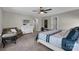 Spacious bedroom with a ceiling fan, a bed dressed in white and blue and a comfortable sitting area at 122 Round Rock Rd, Troutman, NC 28166
