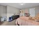 Bright bedroom features a plush carpet and a peach colored comforter with toys and plenty of space at 122 Round Rock Rd, Troutman, NC 28166