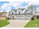 Lovely home with a three-car garage and concrete driveway on a lush green lawn at 122 Round Rock Rd, Troutman, NC 28166