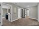 Hallway with neutral paint, carpet and several open doorways leading to other rooms in the home at 122 Round Rock Rd, Troutman, NC 28166
