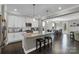 A modern kitchen island is illuminated by pendant lights and features barstool seating at 122 Round Rock Rd, Troutman, NC 28166