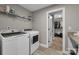 Bright laundry room featuring modern washer and dryer, wire shelving and a doorway to the closet at 122 Round Rock Rd, Troutman, NC 28166