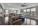 Spacious living room features an oversized sectional couch, dark hardwood floors, and a modern ceiling fan at 122 Round Rock Rd, Troutman, NC 28166