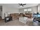 Neutral living room featuring three brown sofas, a glass top coffee table, two windows and a ceiling fan at 122 Round Rock Rd, Troutman, NC 28166