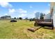 A well-manicured backyard featuring a lawn, deck, and neat planter boxes for gardening at 1249 Maddy Ln, Rock Hill, SC 29732