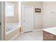 Clean bathroom featuring a soaking tub and a bright tiled floor at 1249 Maddy Ln, Rock Hill, SC 29732