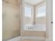 Bathroom featuring soaking tub with tile surround and a glass door shower at 1249 Maddy Ln, Rock Hill, SC 29732