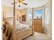 Cozy bedroom with four-poster bed, wooden dresser, and bright natural light at 1249 Maddy Ln, Rock Hill, SC 29732