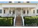 Inviting front porch with stone accents, a decorative front door, and a well-maintained landscape at 1249 Maddy Ln, Rock Hill, SC 29732