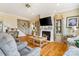 Comfortable living room featuring hardwood floors, fireplace, and staircase leading to the second floor at 1249 Maddy Ln, Rock Hill, SC 29732
