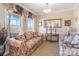 Inviting living room with floral sofa, large windows, and a decorative mirror at 1249 Maddy Ln, Rock Hill, SC 29732