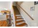 A staircase with hardwood steps and access to the kitchen at 1249 Maddy Ln, Rock Hill, SC 29732