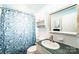 Well-lit bathroom with a modern sink, vanity, and decorative shower curtain for a fresh feel at 1285 Riverview Dr, Hickory, NC 28602