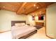Basement bedroom with cozy neutral tones, wood beam ceilings, and a comfortable sleeping area at 1285 Riverview Dr, Hickory, NC 28602