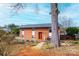 Attractive brick home with a red front door and stone walkway, surrounded by mature trees at 1285 Riverview Dr, Hickory, NC 28602
