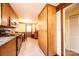 Well-lit kitchen with tile floors, wood cabinets, stainless appliances, and a breakfast bar at 1285 Riverview Dr, Hickory, NC 28602