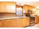 Bright kitchen featuring wooden cabinets, stainless steel appliances, and a mosaic tile backsplash at 1285 Riverview Dr, Hickory, NC 28602