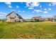 Large backyard with well maintained lawn, a patio with seating, and a shed in the distance at 135 Goldenrod Cir, Salisbury, NC 28147