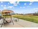 The backyard features a concrete patio with outdoor seating, a grill and a shed in the distance at 135 Goldenrod Cir, Salisbury, NC 28147