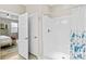 Bright bathroom featuring a white shower and a door leading to an adjacent room with neutral walls at 135 Goldenrod Cir, Salisbury, NC 28147