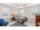 Neutral-toned bedroom with ceiling fan, plush carpet, and ample natural light from three windows at 135 Goldenrod Cir, Salisbury, NC 28147