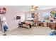 Bright pink bedroom with multiple windows, a ceiling fan, TV, desk and carpeted floors at 135 Goldenrod Cir, Salisbury, NC 28147