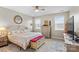 Cozy bedroom with a ceiling fan, two windows, and a stylish bed with decorative pillows and linens at 135 Goldenrod Cir, Salisbury, NC 28147