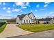 Two-story home with white siding, black roof, two-car garage and well maintained green lawn at 135 Goldenrod Cir, Salisbury, NC 28147
