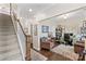 Open floorplan with staircase leading to home office, furnished with computer desk and armchairs at 135 Goldenrod Cir, Salisbury, NC 28147